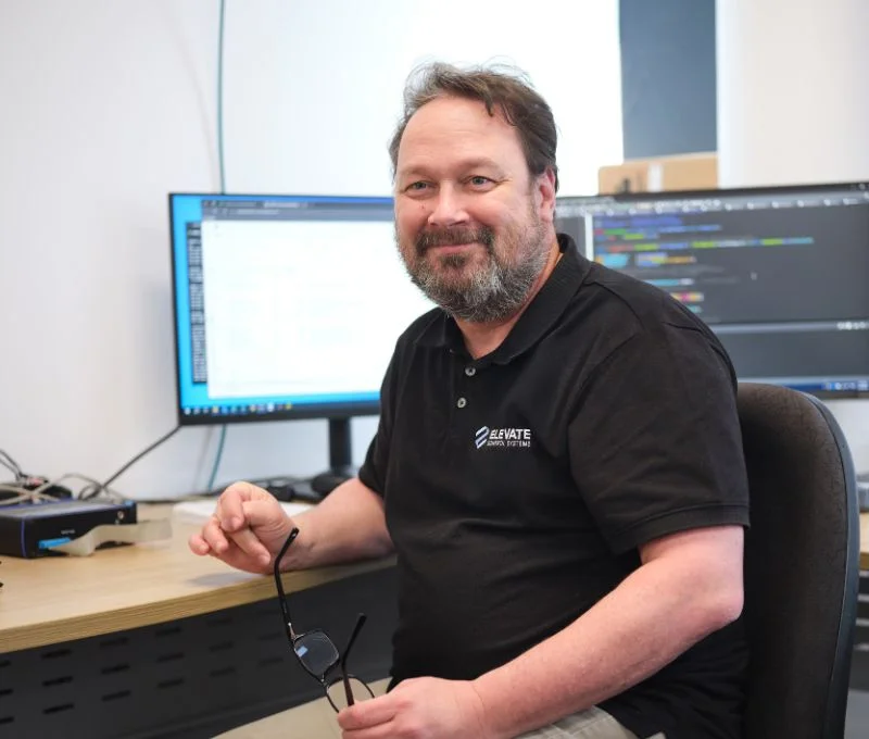 Engineer looking at the camera while coding