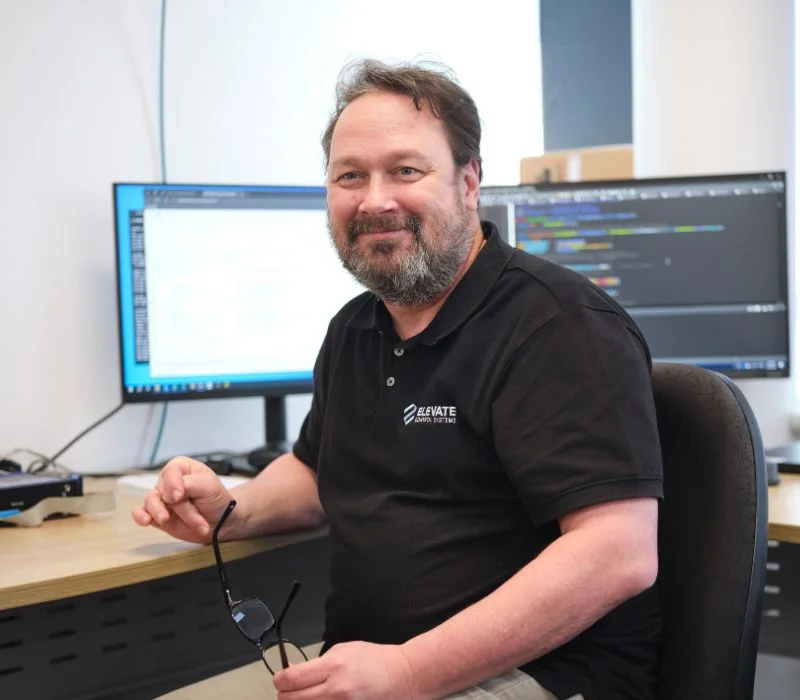 Engineer looking at the camera while coding